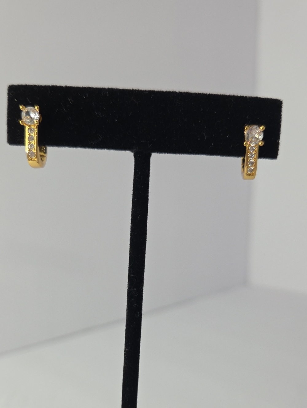 Huggie hoop earrings featuring small pavé-set rhinestones 925 non tested